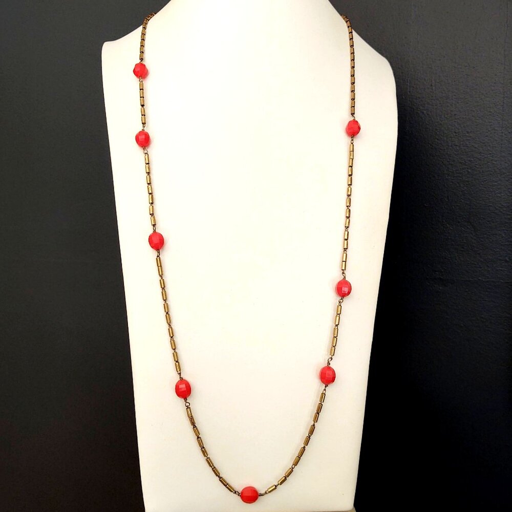Brass/gold tubular metal link necklace with bright melon faceted beads